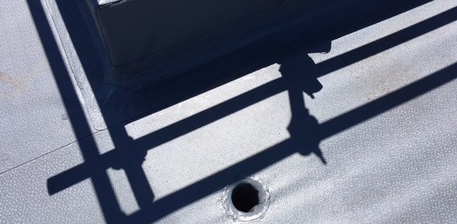 drainage hole on commercial flat roofing
