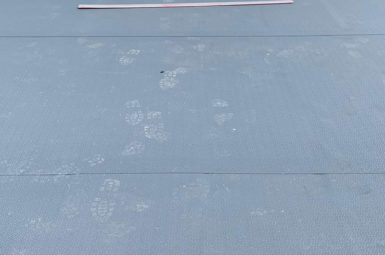 commercial flat roofing with footprints